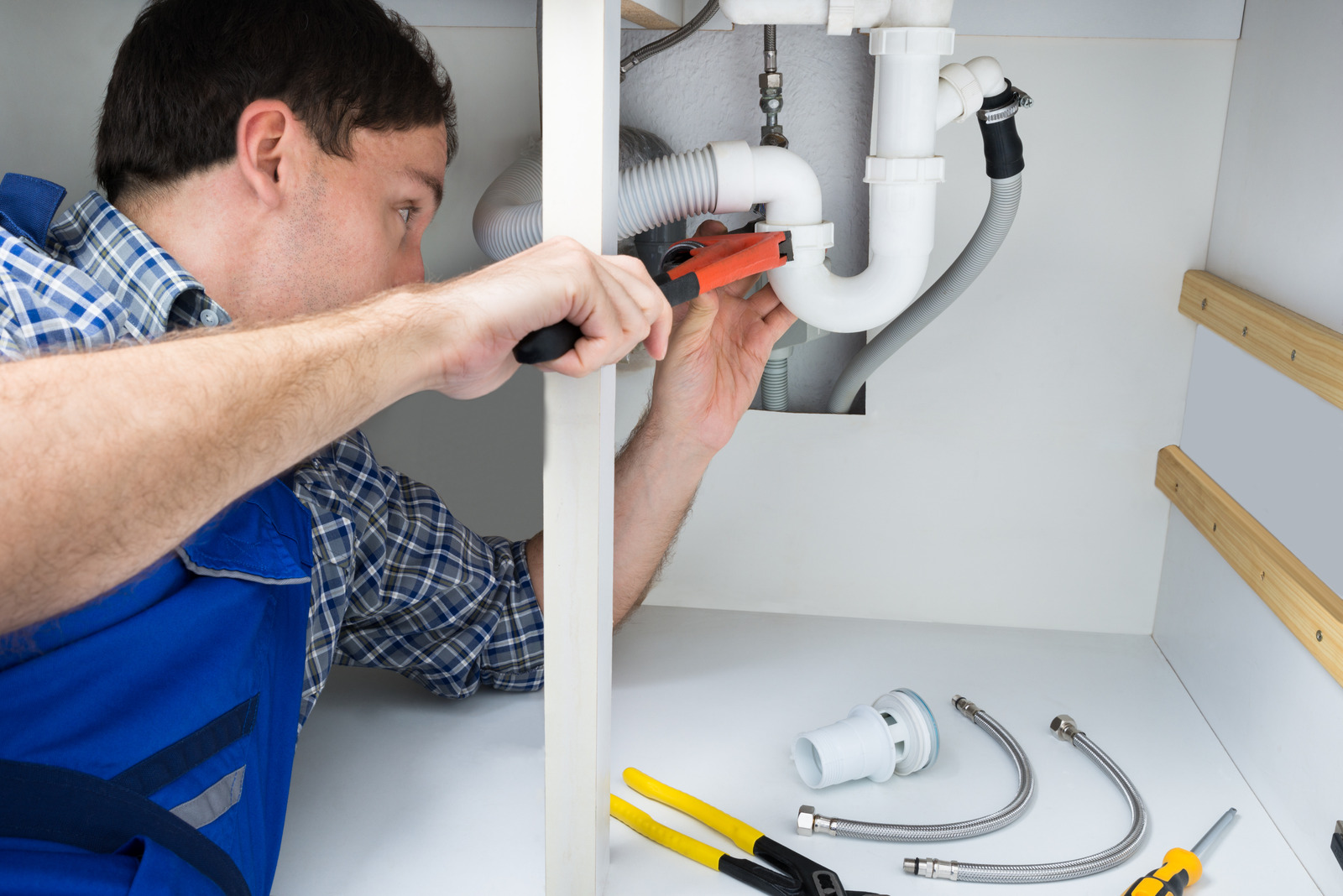 Plumber Fixing Sink In Bathroom